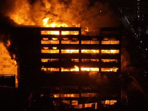 Aerial view of a large industrial building at Chattogram EPZ engulfed in intense flames and smoke during a night fire in Chittagong, Chittagong Division, Bangladesh.