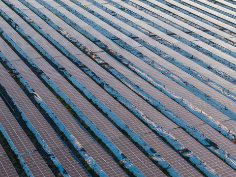 Aerial view of PLTS Medco Solar Bali Timur featuring rows of solar panels capturing sunlight in Kubu, Bali, Indonesia.