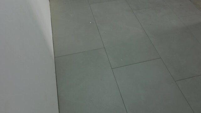 Gray floor tiles installed in residential interior