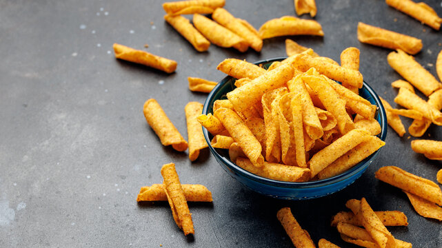 Rolled Tortilla Corn Chips in Blue Bowl on dark background