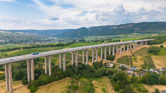 Aerial view of the Mosel Viaduct Longuich highway bridge spanning the lush green vineyards of the Moselle valley in Trier-Saarburg, Rhineland-Palatinate, Germany.