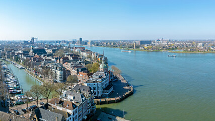 Obraz premium Historic riverside city with prominent waterfront landmark in Europe