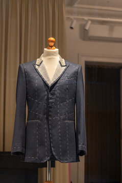 Tailor&rsquo;s unfinished suit jacket on a mannequin in a bright professional studio