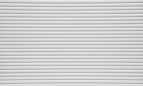 White roller shutter door texture background with horizontal parallel lines pattern