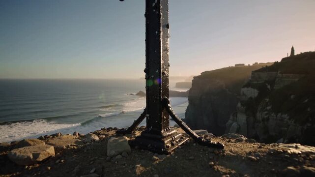 Pulling back camera lowering frame at cliff edge, revealing iron post with barnacles, showing coast