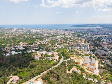 Aerial view of the coastal city of Varna with residential buildings, green hills, and the Black Sea in the background in Varna, Varna, Bulgaria.