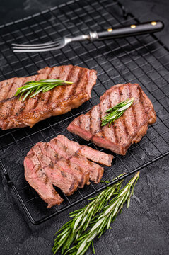 Grilled Top blade steak, shoulder beef meat. black background. top view