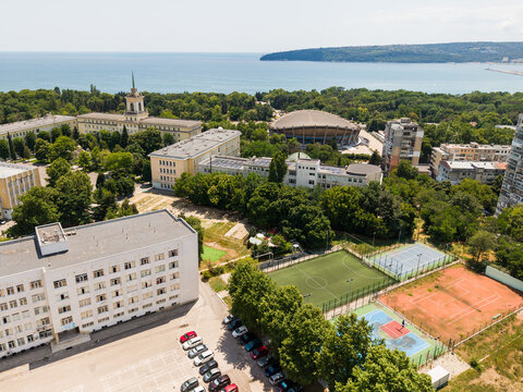 Aerial view of the Nikola Vaptsarov Naval Academy campus featuring sports fields, academic buildings, and the Black Sea in the background in Varna, Varna, Bulgaria.
