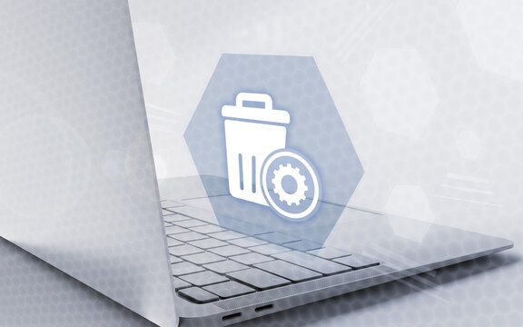 Digital concept showing a laptop computer combined with a trash bin icon and gear settings symbol representing file deletion, data management, and system maintenance.