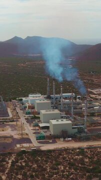 Aerial orbit shot moving right to left around power plant, Baja California Sur, Mexico