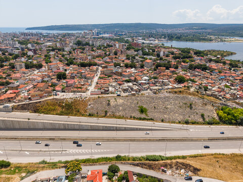 Aerial view of the Maksuda neighborhood with its dense residential buildings and red-tiled roofs situated near the highway and Varna Lake in Varna, Varna, Bulgaria.