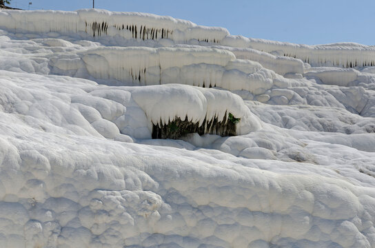 Pamukkale Turkey travertine terraces white mineral formations thermal springs ancient landscape blue sky natural wonder tourism destination geology calcium pools