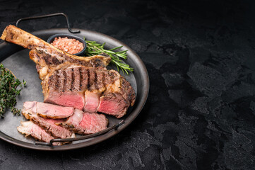 Roasted Tomahawk beef steak, roast dry aged rib eye with bone. black background. top view © Mironov