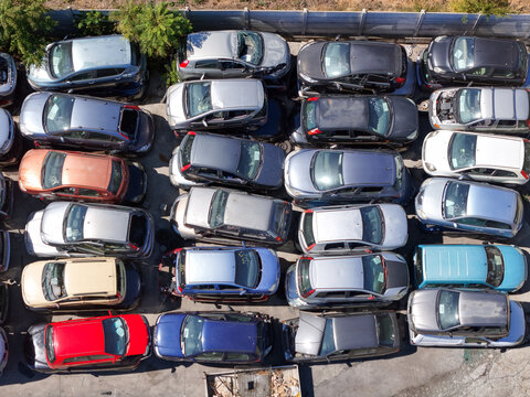 Aerial view of end-of-life vehicles parked in rows at a car scrapyard in Spinetta Marengo, Piedmont, Italy.