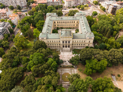 Aerial view of Varna Museum of Archaeology surrounded by lush green trees and urban parkland in Varna, Varna, Bulgaria.