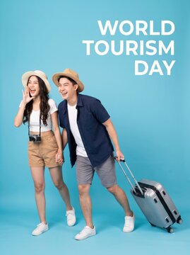 Happy World Tourism Day with Asian couple traveling with luggage, excited for vacation.