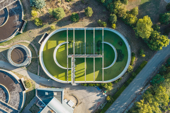 Aerial view of a green water clarification basin at a wastewater treatment plant in Valence, Auvergne-Rhone-Alpes, France.