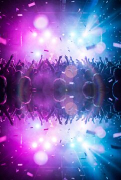 Crowd dancing at a nightclub with colorful stage lights and falling confetti