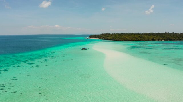 Sand bar in transparent turquoise water top view. Tropical beach with tourists. Mansalangan sandbar, Balabac, Palawan, Philippines. Summer and travel vacation concept