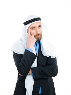 Thoughtful Arab businessman wearing keffiyeh thinking and looking up isolated on white background.