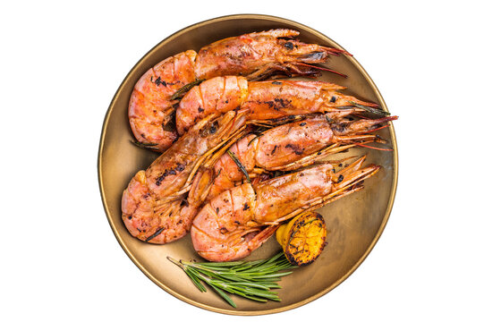 Grilled red Argentine shrimps, Prawns Langostino Austral on a plate with herbs isolated on white background. top view