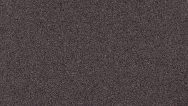 Dark grey grainy texture background full frame fine noise stone paper asphalt surface overlay pattern for graphic design