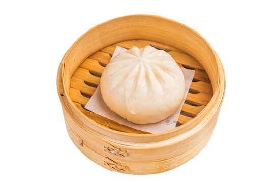 Chinese Bao or Baozi bun with meat in bamboo steamer isolated on white background. top view