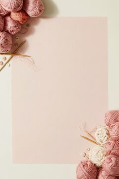 Pink background with knitting yarn balls and wooden needles, creating a soft and cozy composition for craft and hobby campaigns with copy space