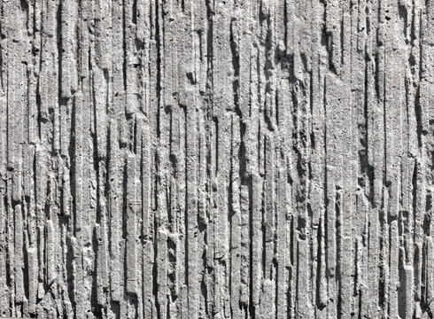 Decorative vertical grooved concrete wall texture, grey linear stucco relief background for modern architectural design with copy space