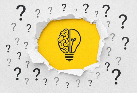 Creative concept with a human brain and light bulb icon surrounded by many question marks