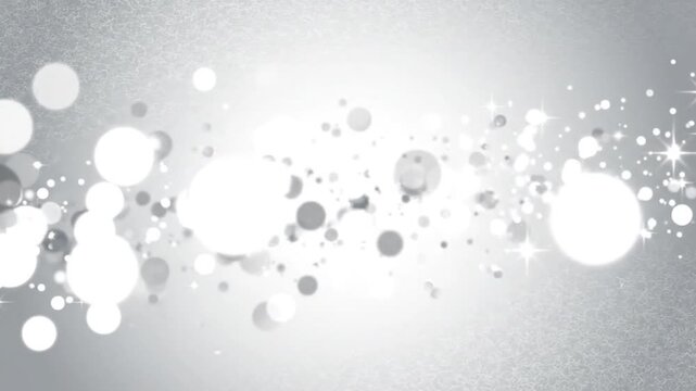 Abstract white bokeh circles on gray gradient background.