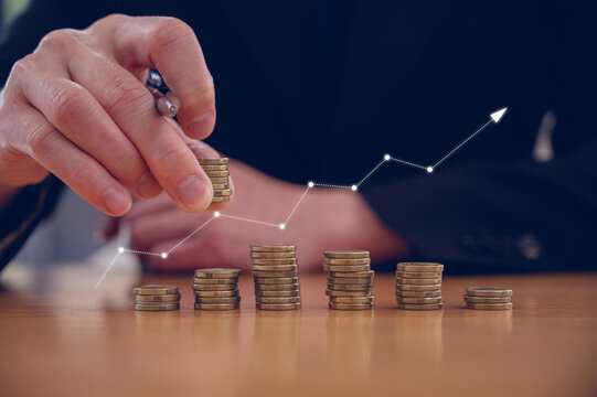 Investment and finance concept, businessman stacking coins and virtual arrow up, stock market, profits and business growth.