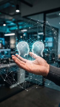 A hand holds a network connecting two stylized heads with gears, symbolizing AI and connection, representative of technology and communication