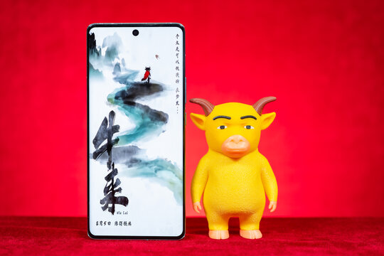 ZhongShan GuangDong China-August 27 2026: Smartphone showing Niu Lai movie poster beside Niu Lai toy model at horizontal composition.