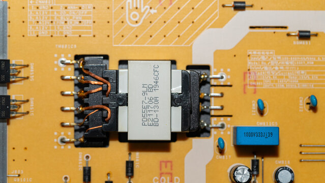 Switch mode power supply transformer on yellow printed circuit board