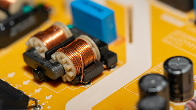 Perspective close up of dual copper inductor coils on circuit board