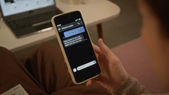 Unrecognizable woman reading scam text on smartphone while holding bank card, dropping card in disbelief. Footage suited for cybersecurity awareness and online banking fraud prevention