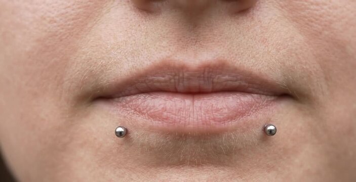 Close Up of Woman Lips with Snake Bites Piercing Featuring Double Silver Ball Labret Studs
