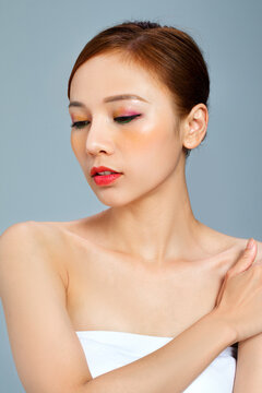 Woman with Glam Makeup Holding Shoulder