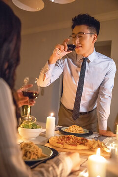 Candlelit romantic dinner date with wine toast