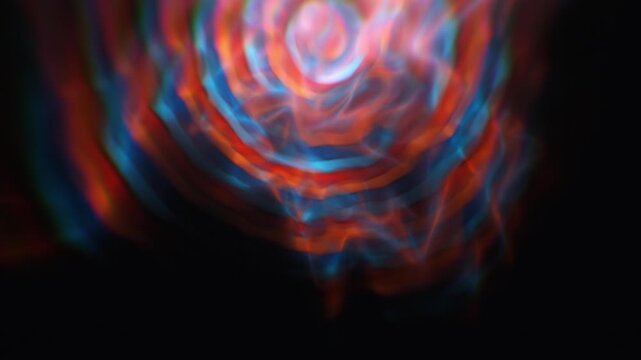 Intertwined orange and cyan caustic fluid light streams wave smoothly across a dark ambient plane in a 3D animation