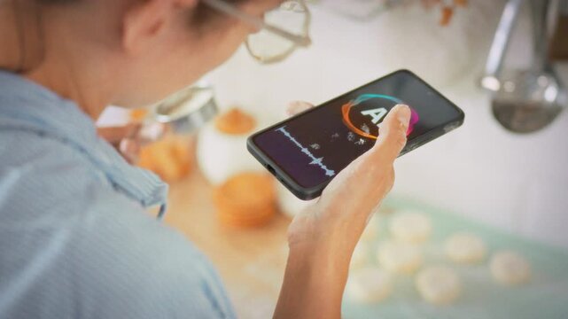 Voice assistant gives step-by-step instructions for making cottage cheese pancakes while housewife cooks in a home kitchen. Concept of applying artificial intelligence as a personal culinary advisor