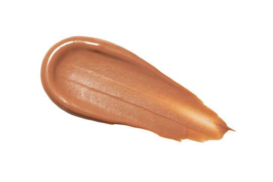 A thick smear of brown liquid foundation makeup with creamy texture isolated on a transparent background