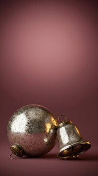 Vintage glass ball and bell with metallic finish positioned against a soft pink background, showcasing reflective surfaces and intricate details