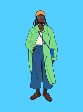 Black woman fashionable model in green long coat and orange beanie with braids and glasses