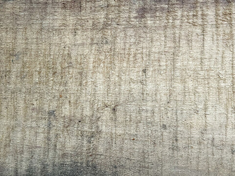 Pale gray weathered wood with a bleached appearance, dense rough-sawn marks, and a dark worn lower edge in a horizontal format