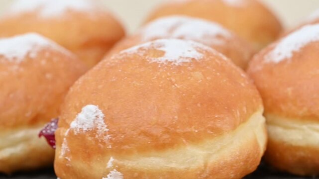 Video of Berliners (German donuts) with raspberry jam