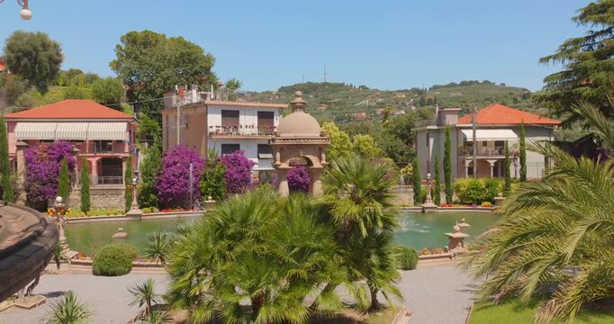 Lush gardens and ornate pond outside Villa Grock on a sunny day in Imperia, Italy