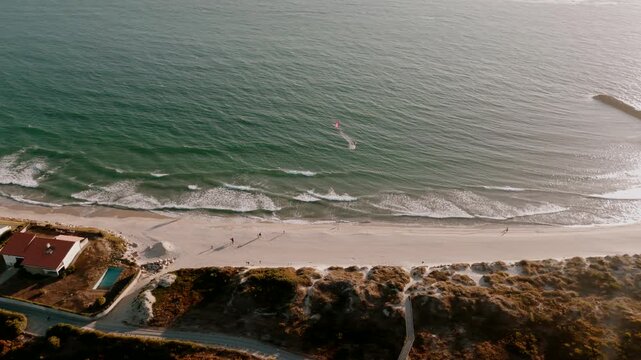 Aerial - Ofir beach in Portugal with breaking waves sand dunes and beachfront house pool