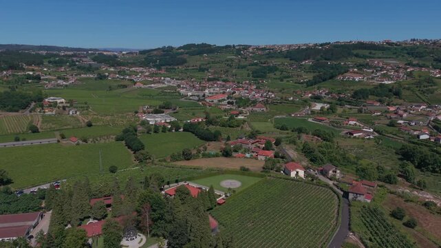 Aerial - Airaes village in Felgueiras Portugal with vineyards farm fields and red roof houses